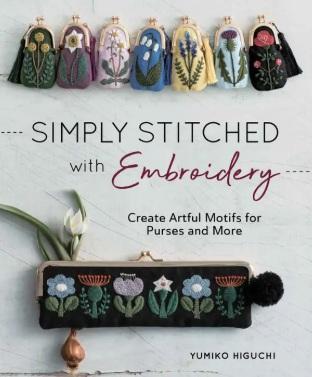 Embroidered fabric pouch with colorful floral motifs and black pom-pom zipper pull