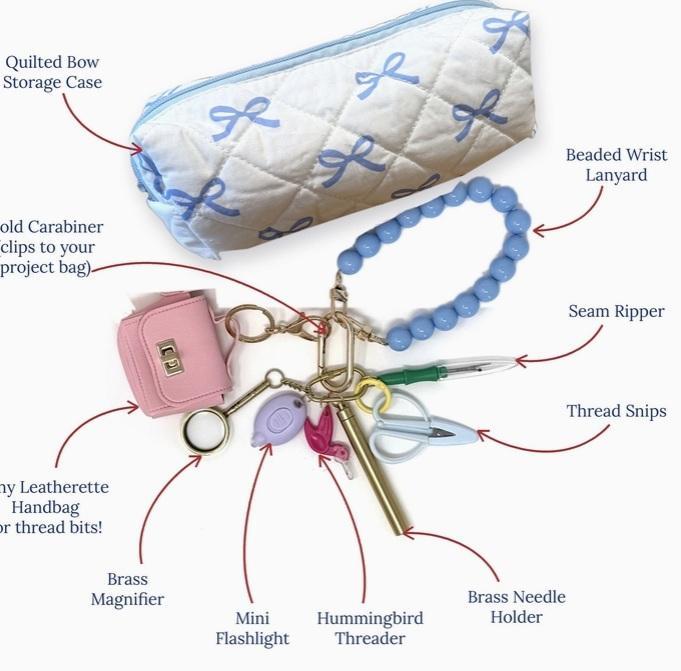 Beaded tool lanyard with blue beads, brass clips, and assorted sewing tools beside a bow-print case