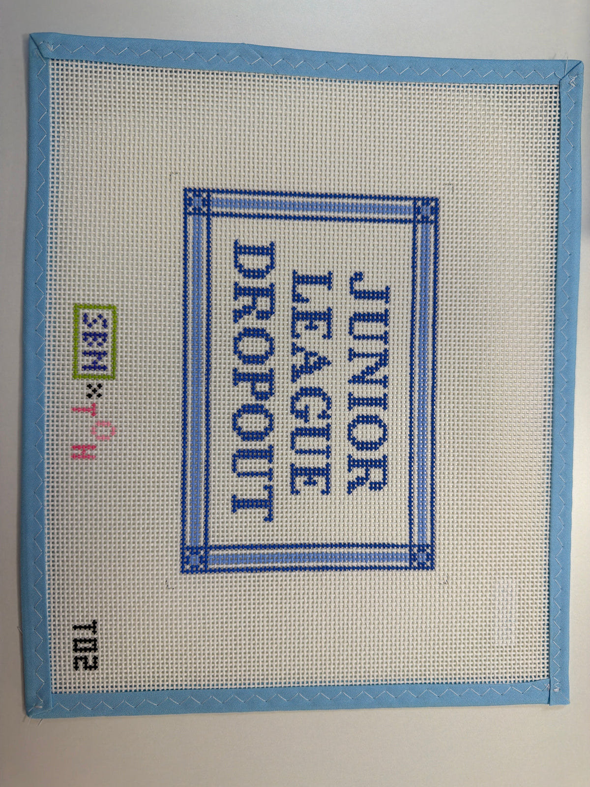 Junior League graphic textile patch in blue and white with border detail