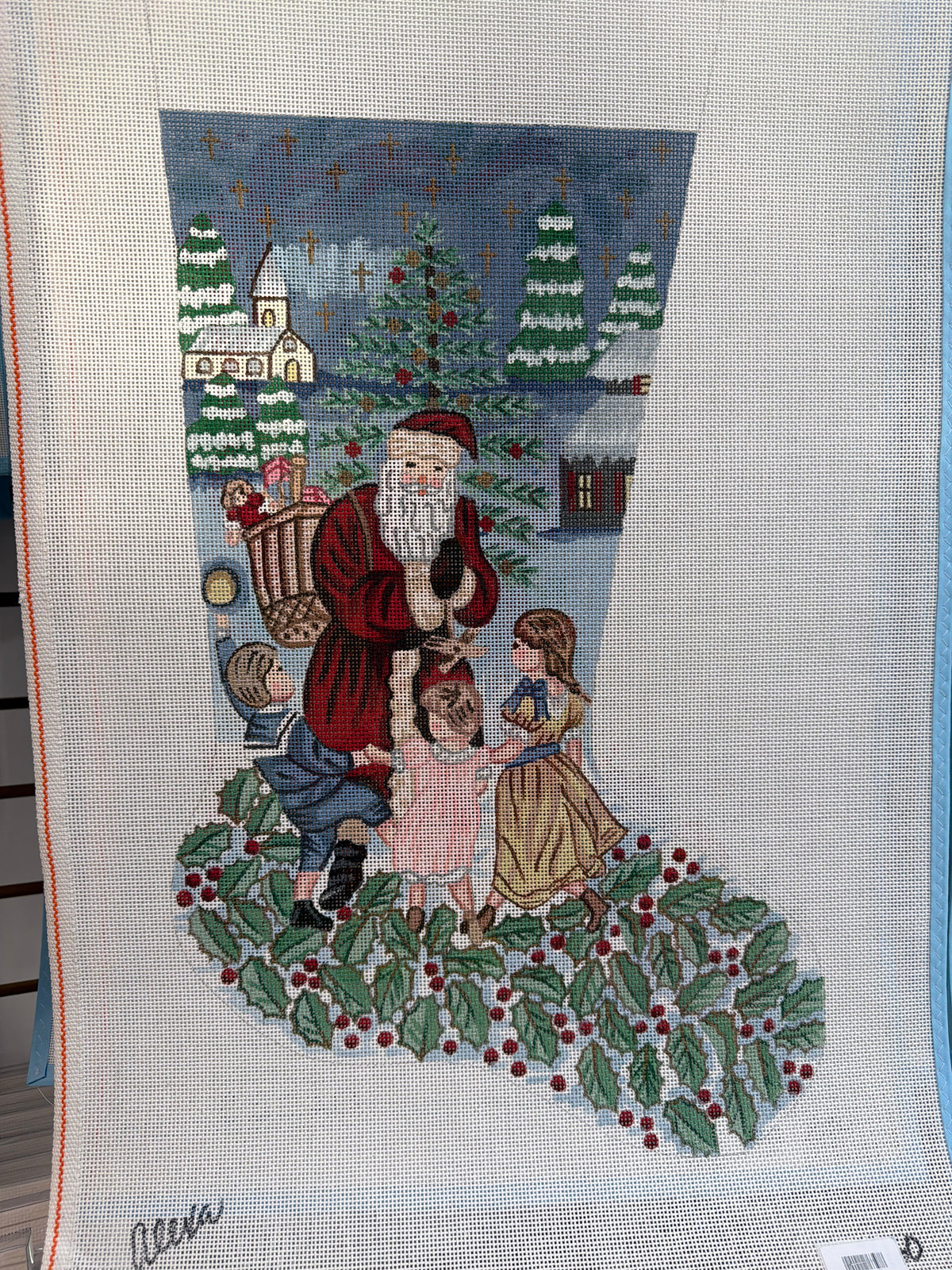 Embroidered Christmas decorative panel with Santa holding a lantern and surrounded by children