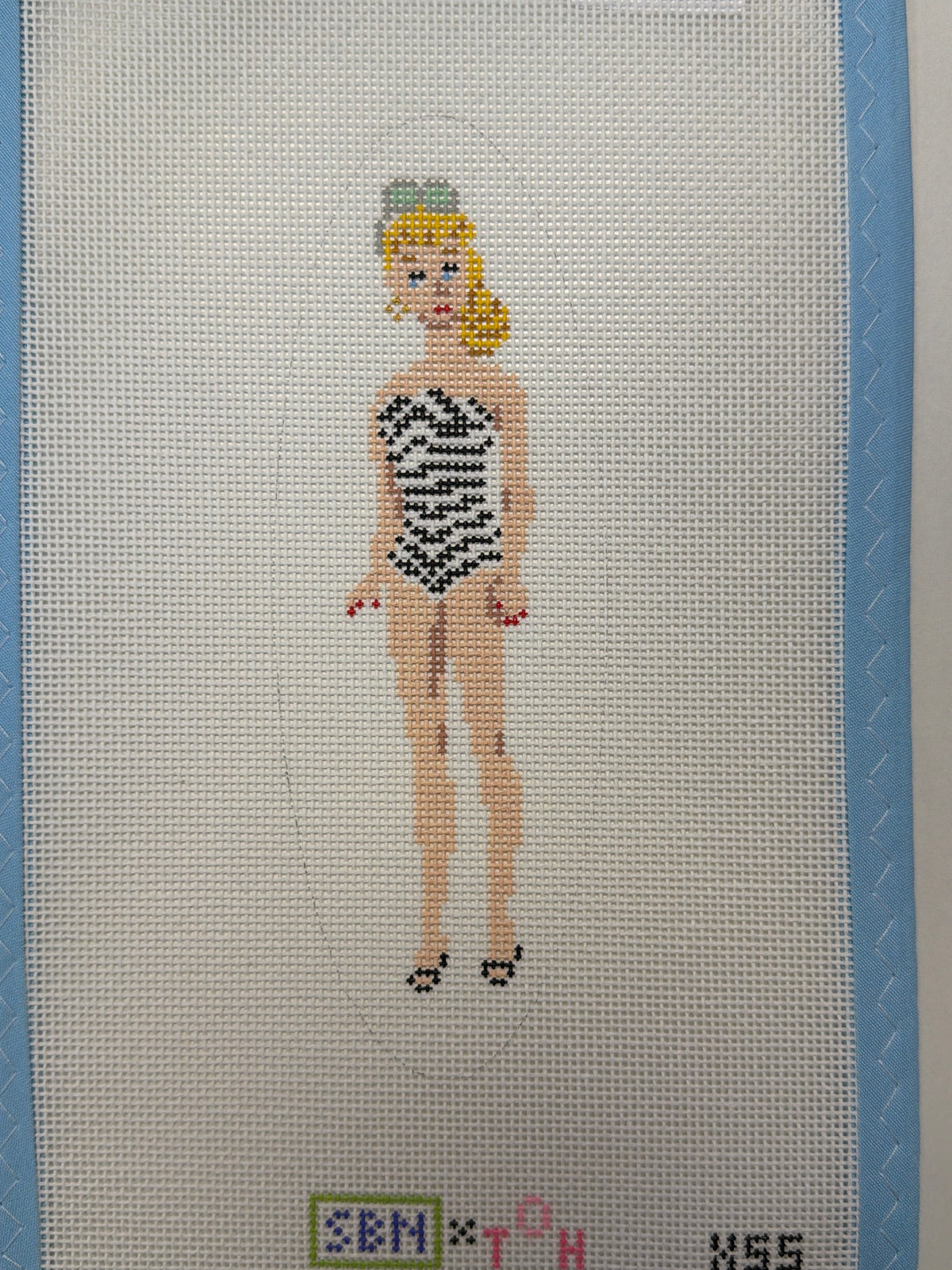 OG Barbie doll figure: standing blonde with black-and-white outfit, beadwork style