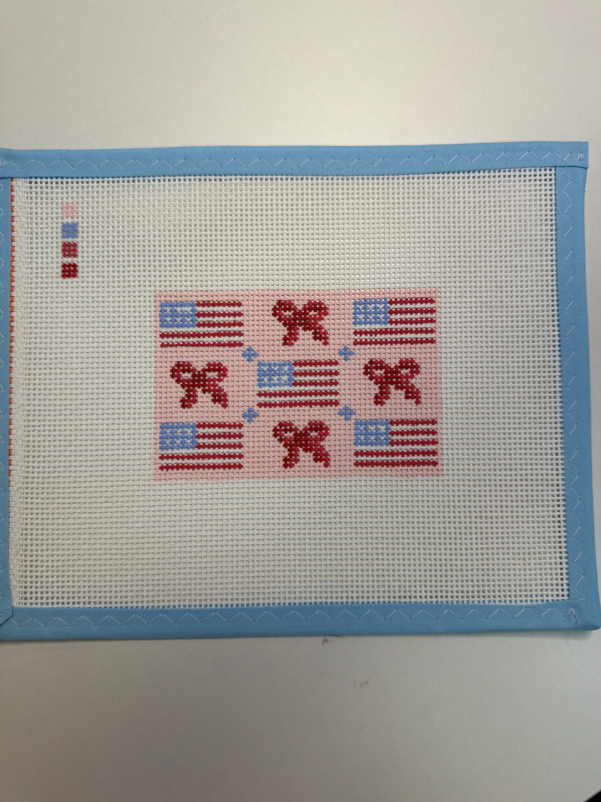 Small rectangular fabric flags patch with red, blue, and white stitched design