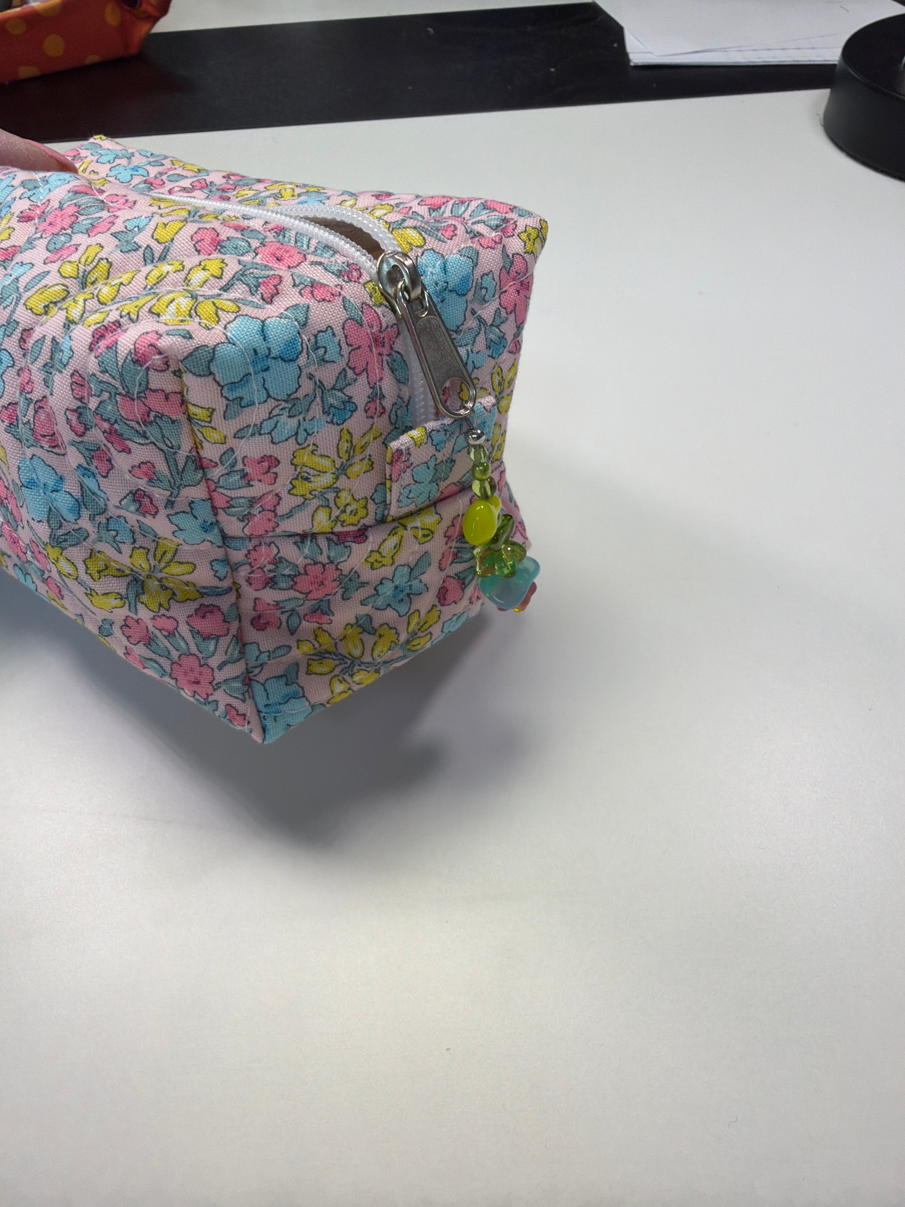 Large quilted zipper pouch, multicolor floral print, blue-pink base, top zipper, tassels