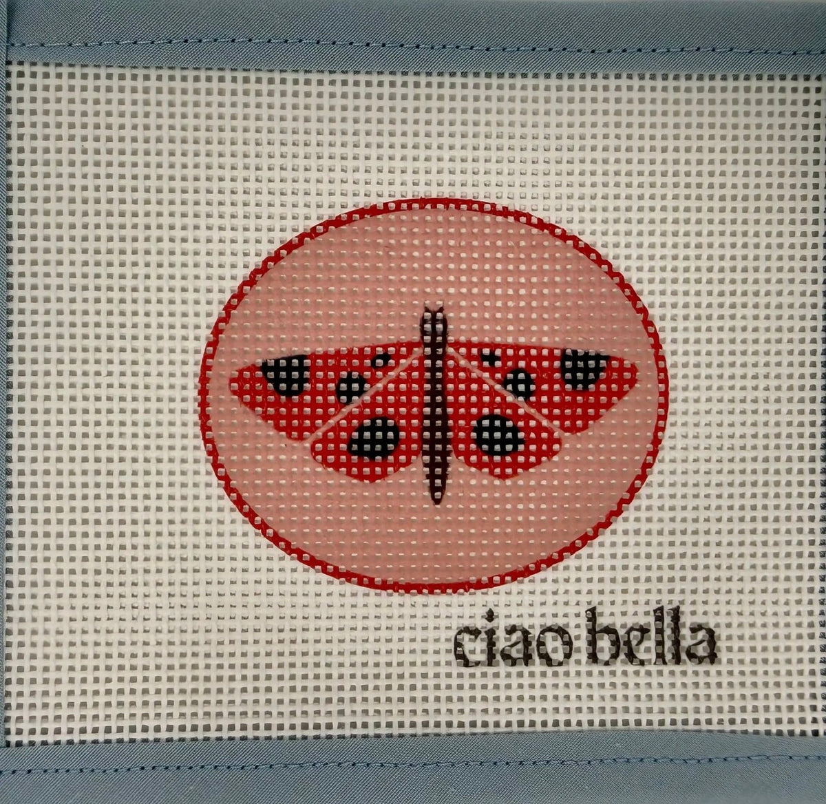 Embroidered fabric patch with red oval butterfly graphic and Ciao bella text