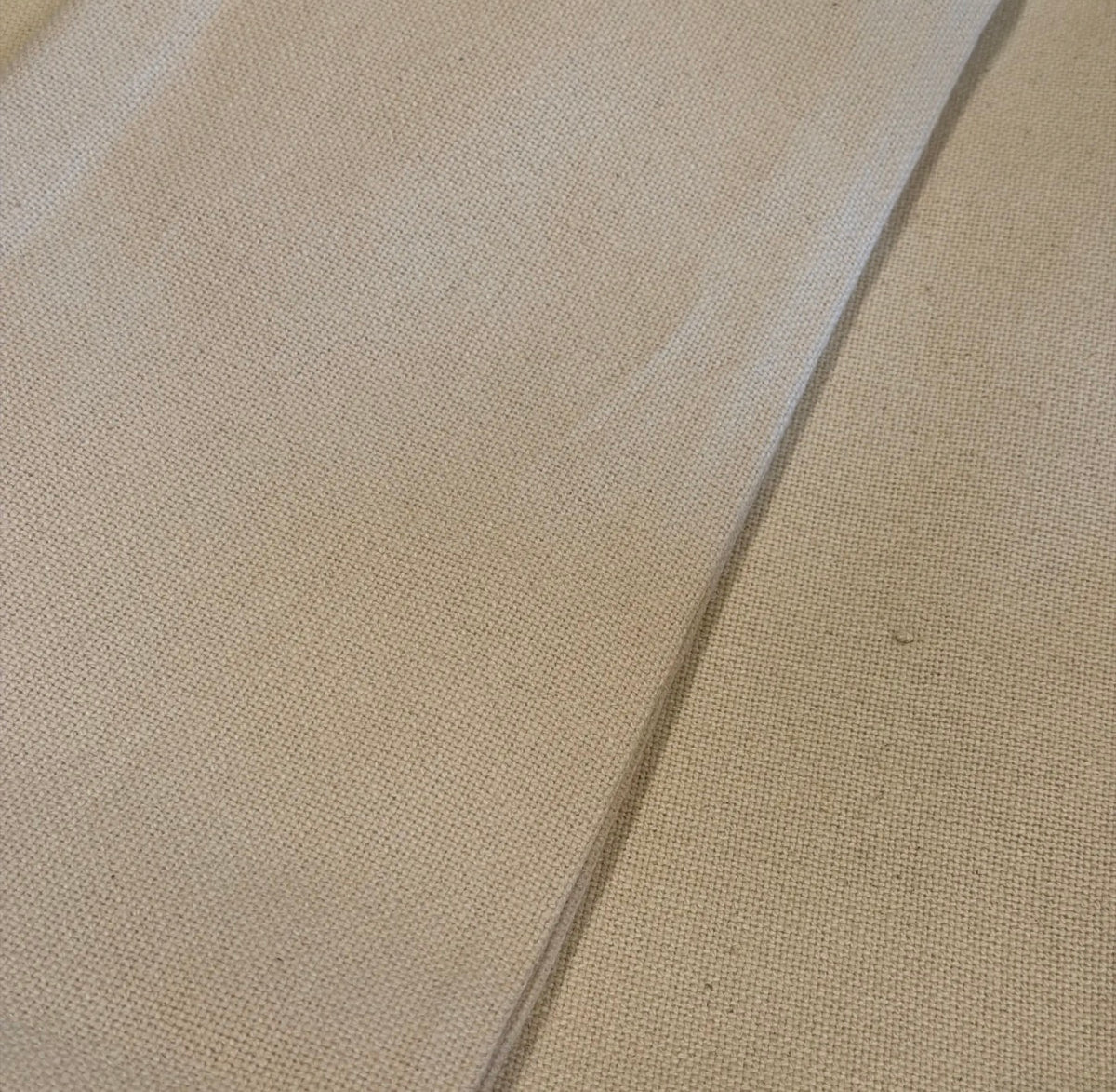Light tan grain sack fabric, visible coarse weave texture