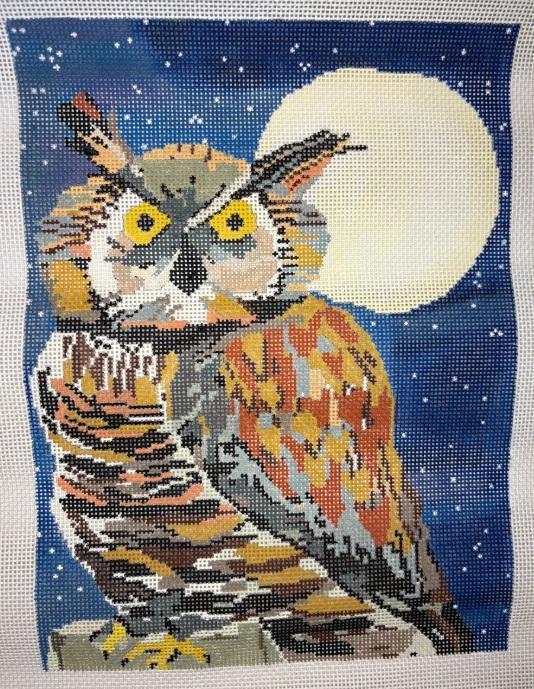 Horned owl cross-stitch square with yellow eyes, orange beak, and dark stripes