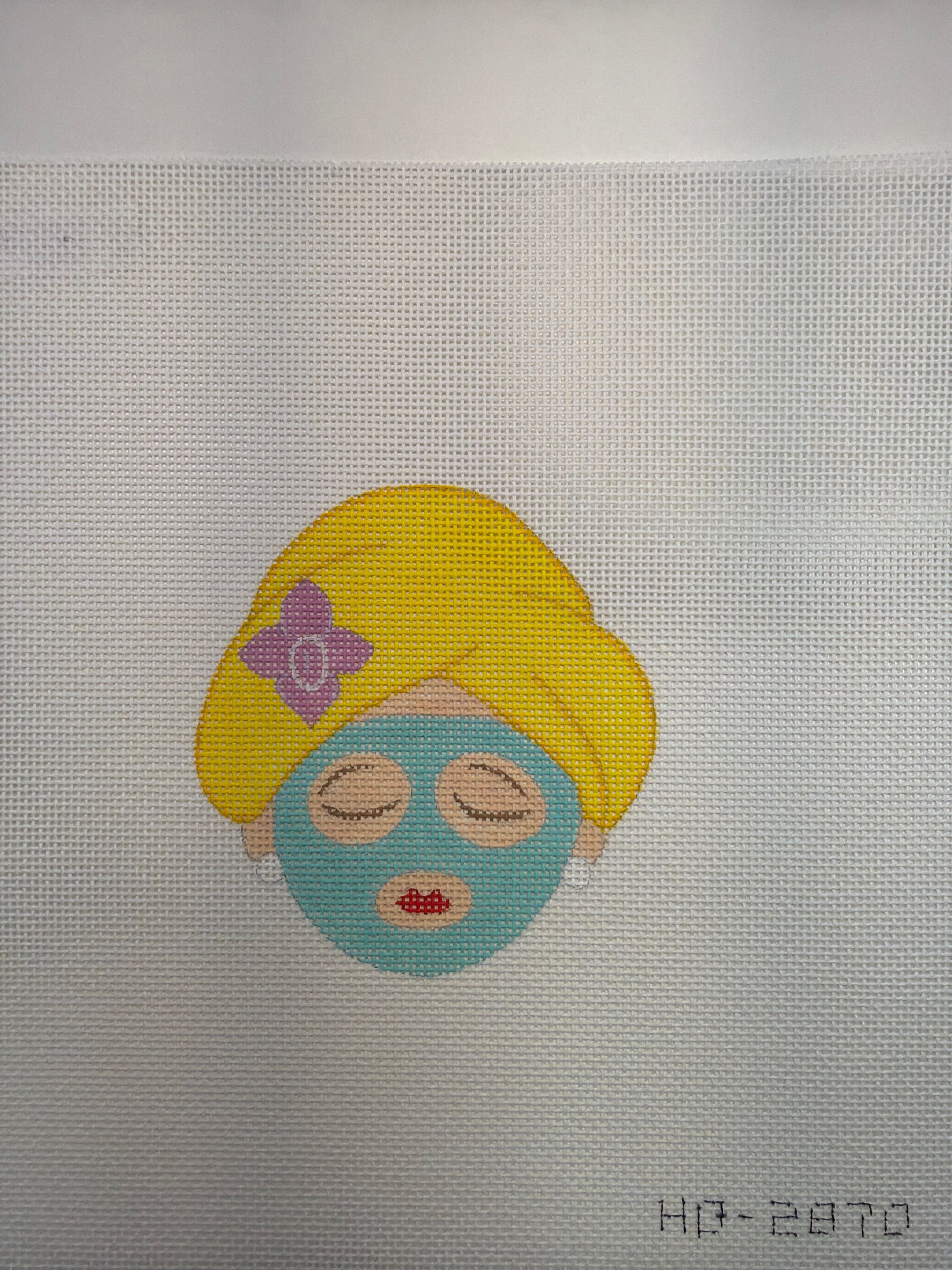 Cartoon spa character patch: blue face with yellow hair hood and eyewear