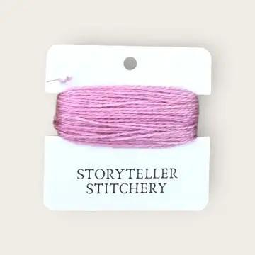 Hand-dyed embroidery thread on card, dusty rose-pink skein with speckled texture