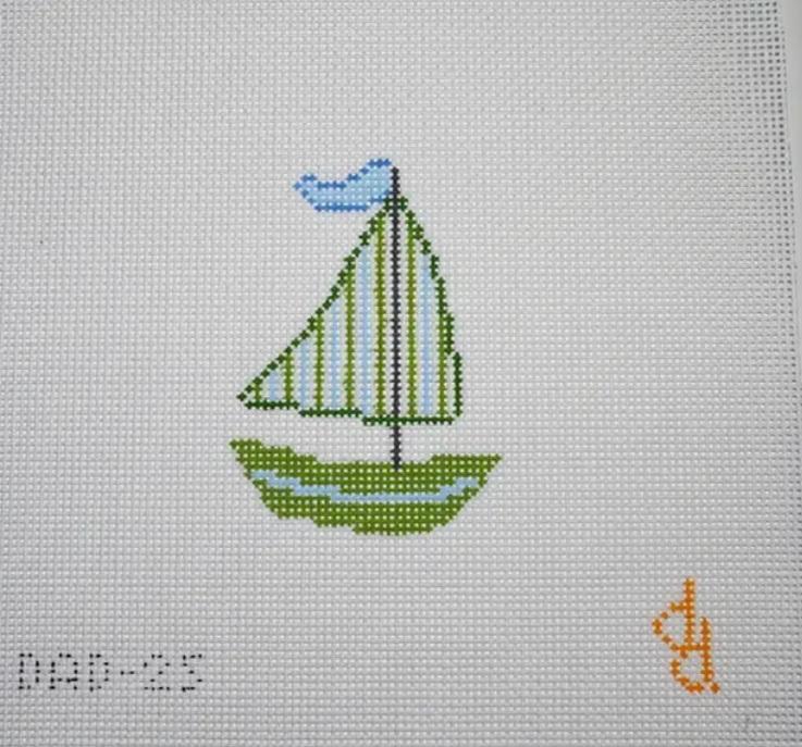 Embroidered sailboat with green striped sails and blue bow over a white backing