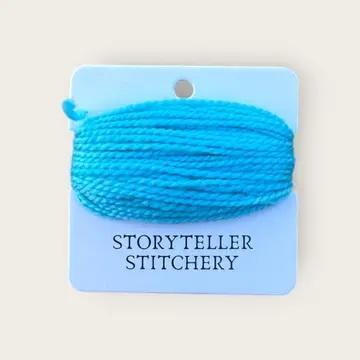 Hand-dyed yarn thread spool, bright blue on a hanging card