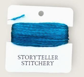 Hand-dyed embroidery thread skein on card, bright blue with fine strand texture