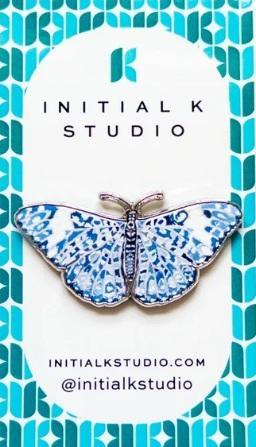 Chinoiserie butterfly needle minder with blue patterned wings and silver-tone frame