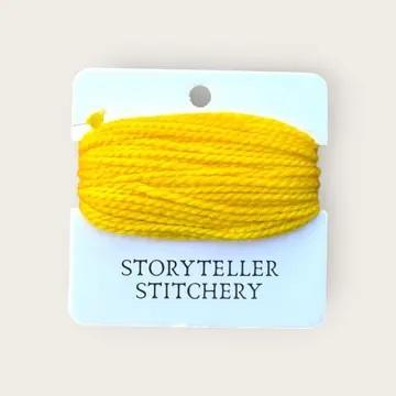 Hand-dyed embroidery thread spool in bright yellow on a card backing.