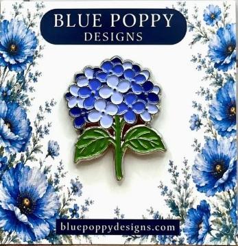 Blue hydrangea enamel needleminder with three layered petals and green leaves