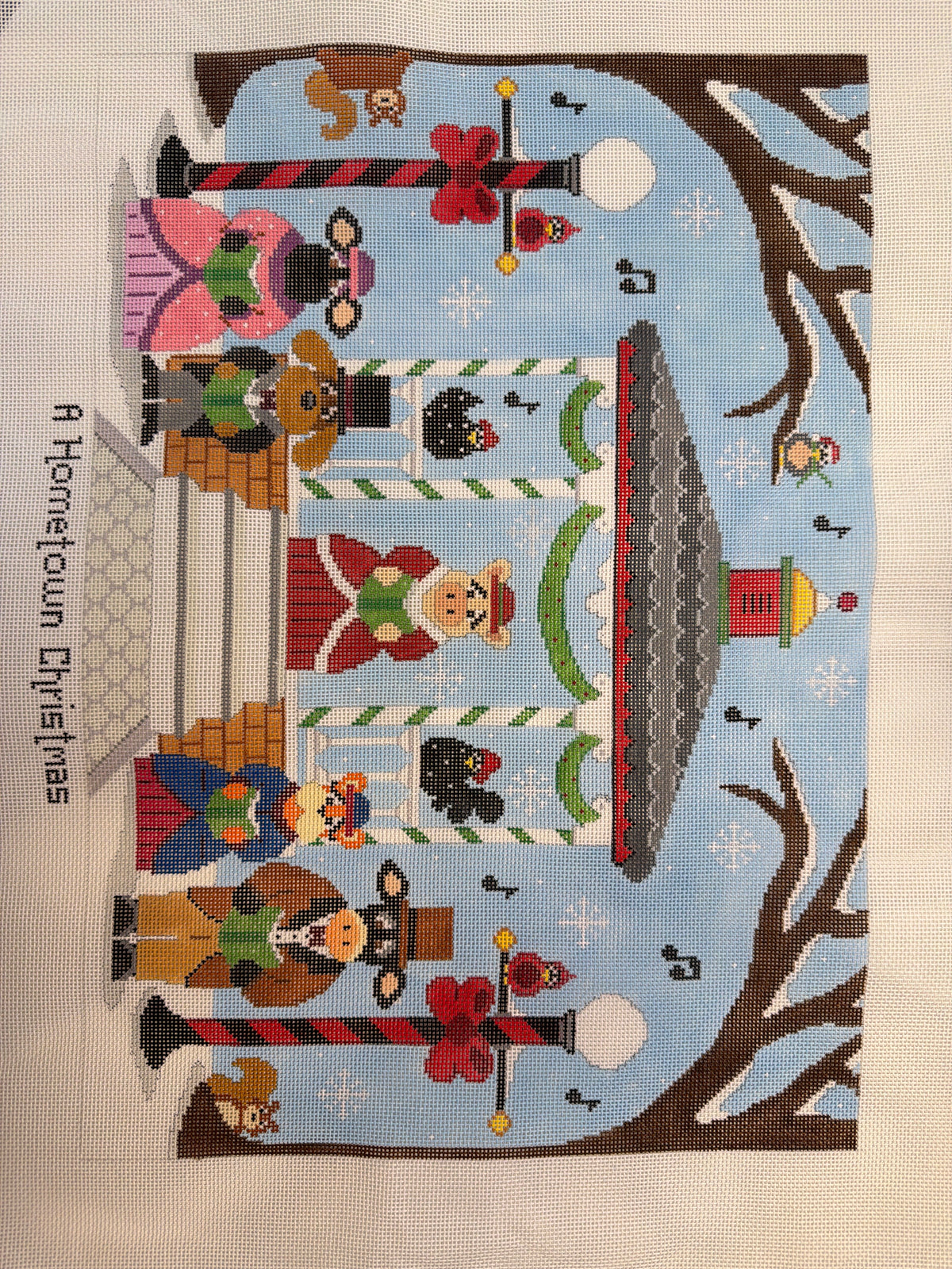 Rectangular Christmas needlework panel with houses, trees, birds, and snowflakes