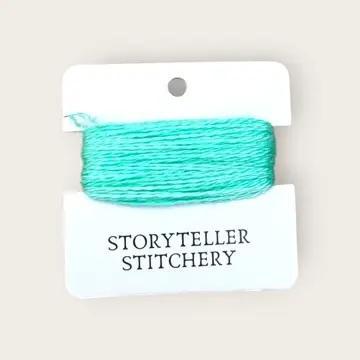 Hand-dyed embroidery thread on card, turquoise-teal skein with subtle marbling