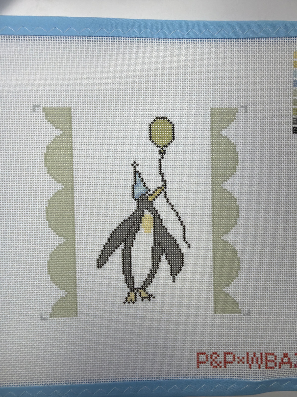 Penguin cross-stitch canvas with yellow balloon and cone party hat