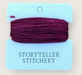 Hand-dyed embroidery thread skein on card, dark plum purple with heathered strands
