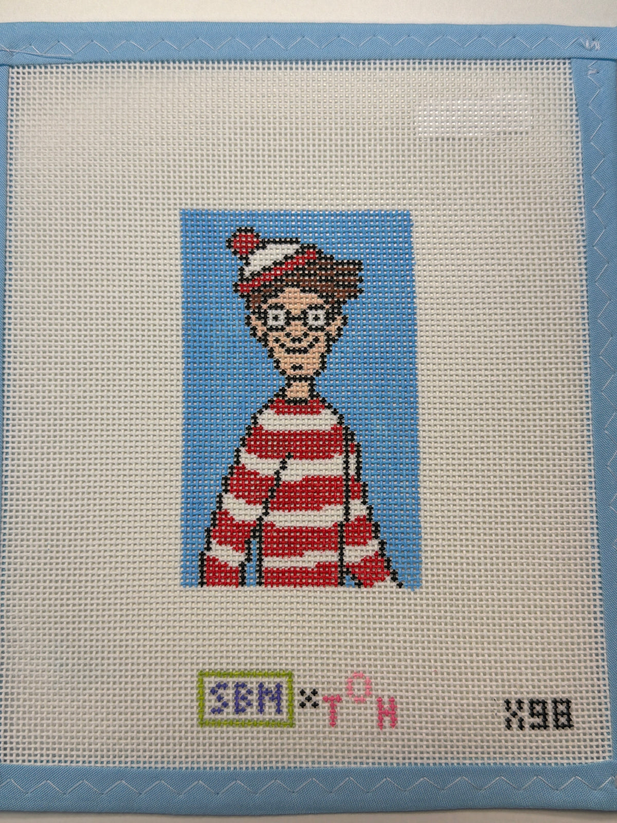 Needlepoint canvas panel with a girl in red dress against a blue background