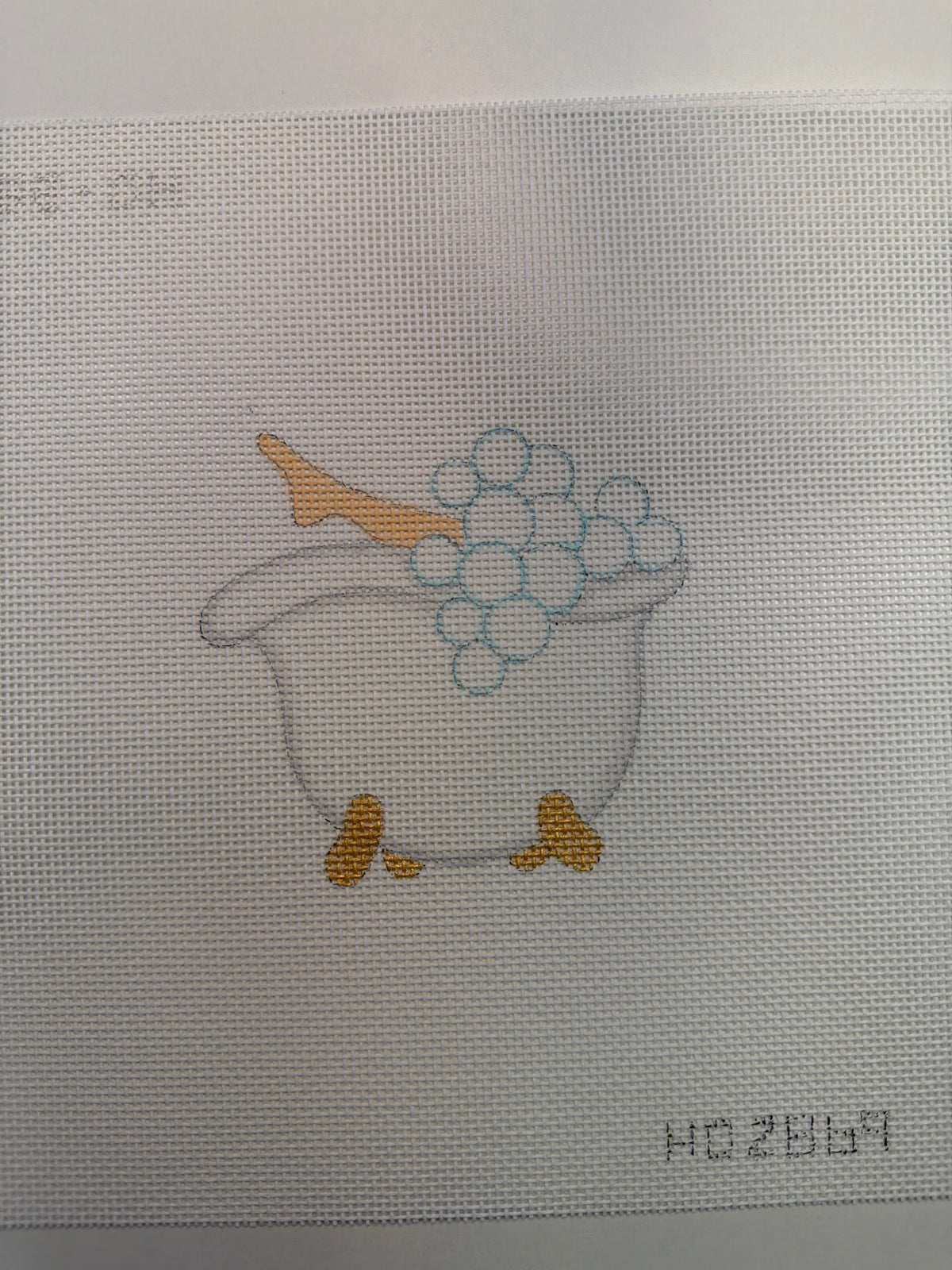 Spa-themed tub embroidery with bubbles and orange feet accents, centered on light fabric