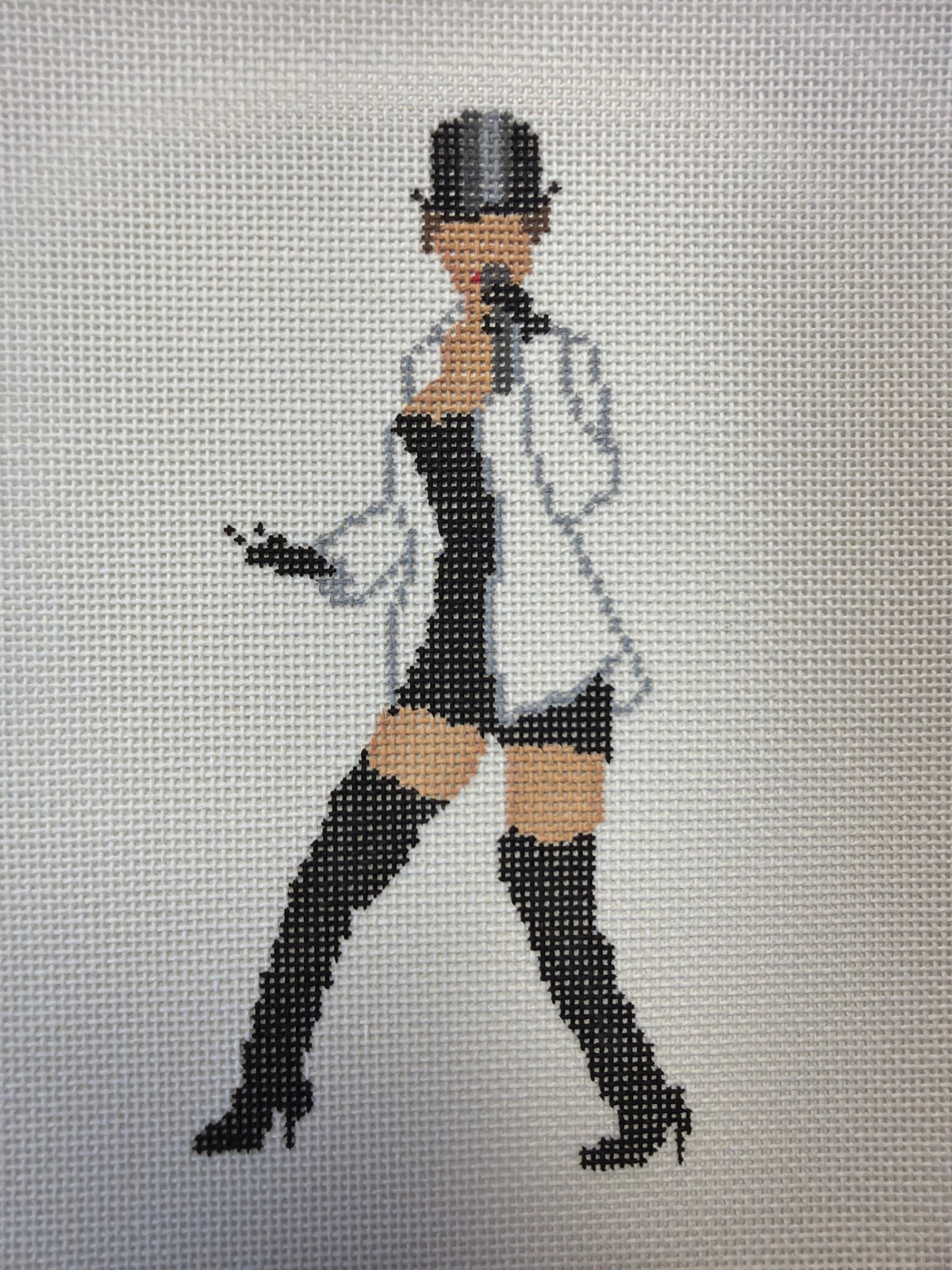 Black top hat with black and white sequin jacket and pants