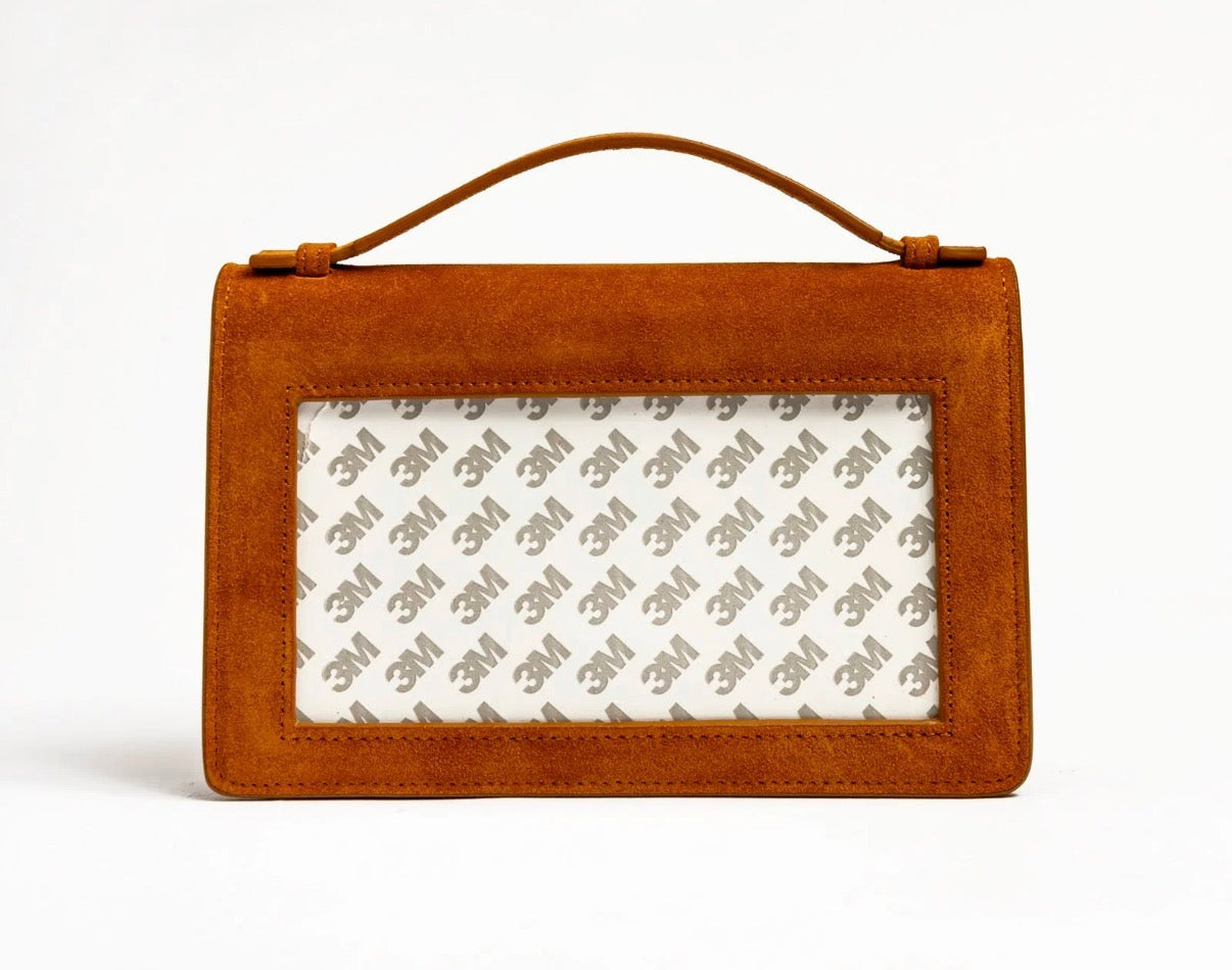 Tan suede-style clutch with top handle and rectangular front window lining