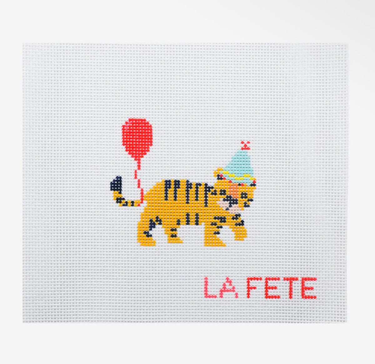 Embroidered yellow tiger party patch with red balloon, party hat, 'LA FETE'.