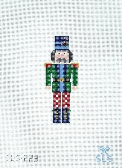Nutcracker decorative figure with blue hat, green jacket, and plaid pants