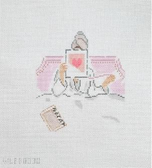 Embroidery design with sewing needle, thread spool, and pink thread on light fabric