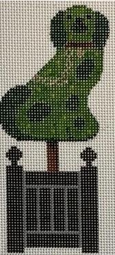 Green dog topiary on black fence planter, side view