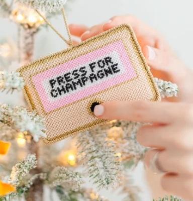Champagne press charm: 'PRESS FOR CHAMPAGNE' on gold mesh pouch