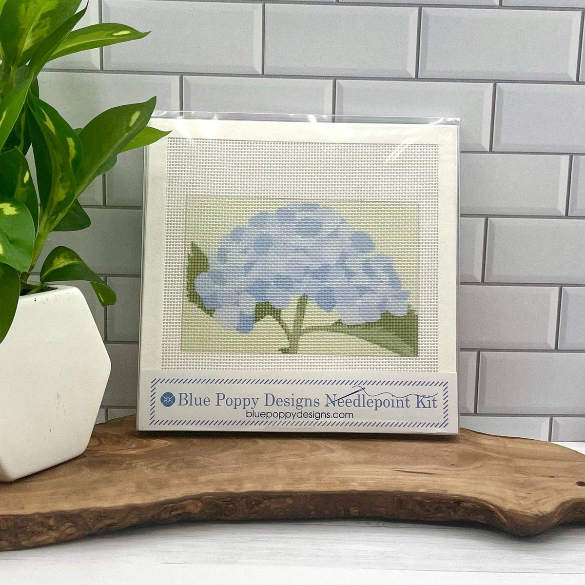 Needlepoint kit with framed canvas featuring blue hydrangea flower motif