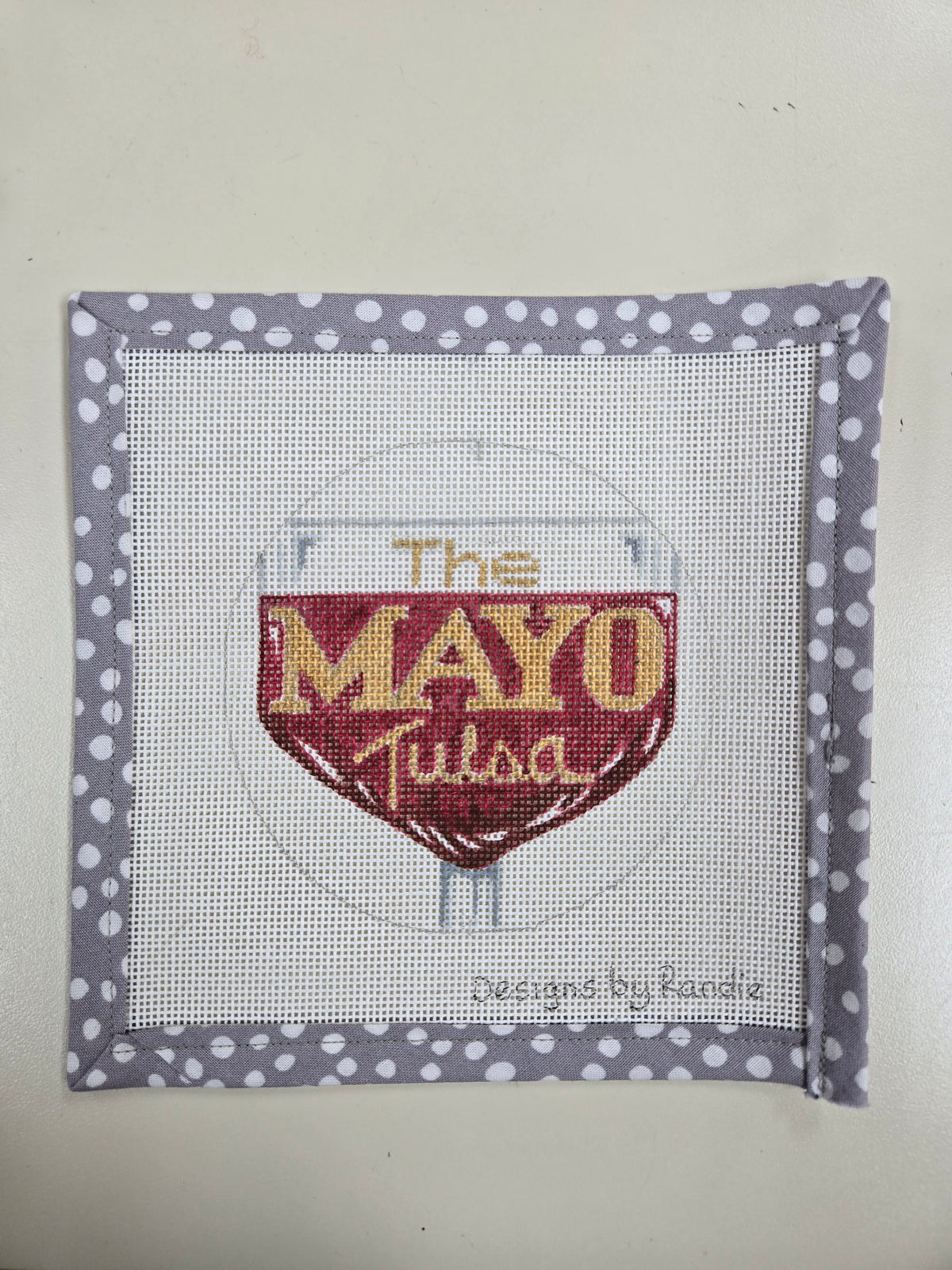 The Mayo wine needlepoint square with a red shield design