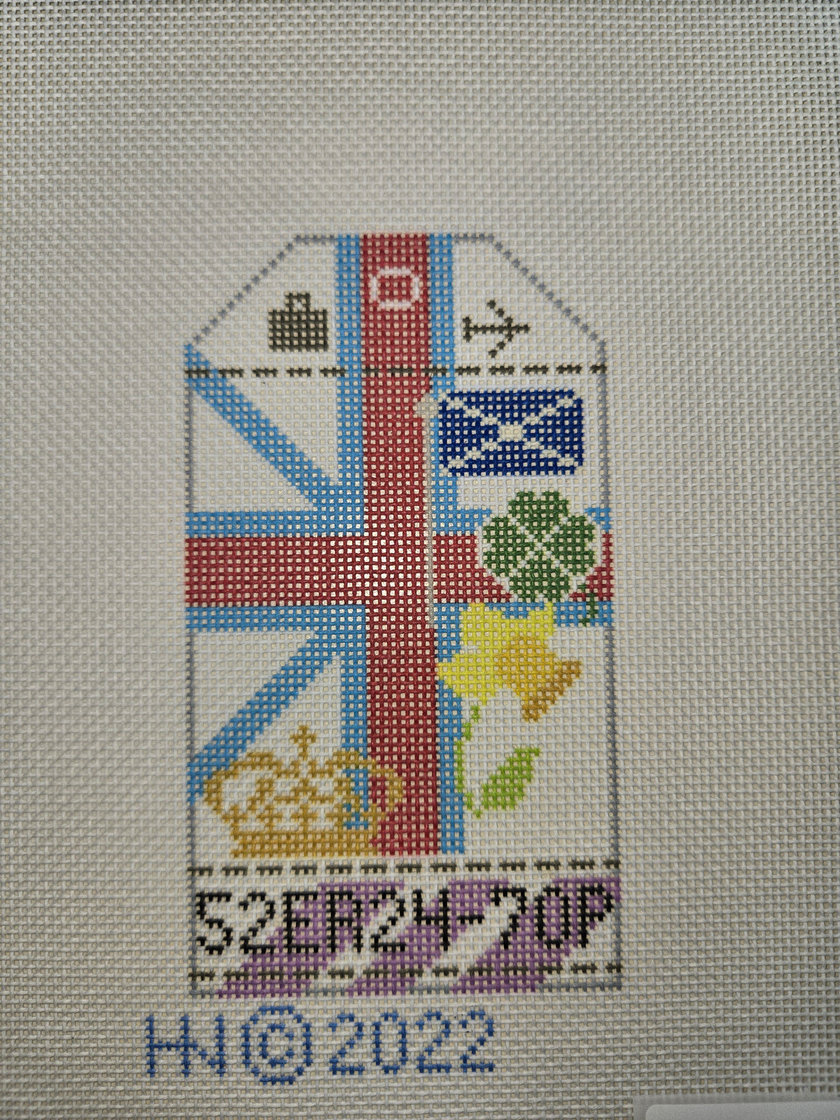 Cross-stitch travel tag with Union Jack and small flags, floral emblems, and Jubilee text