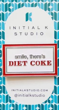 Diet Coke needle minder magnet with red and white "smile, there's DIET COKE" badge
