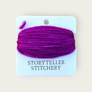 Hand-dyed embroidery thread spool in bright magenta purple on a card backing.
