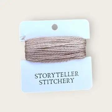 Hand-dyed embroidery thread spool, light beige and gray variegated.
