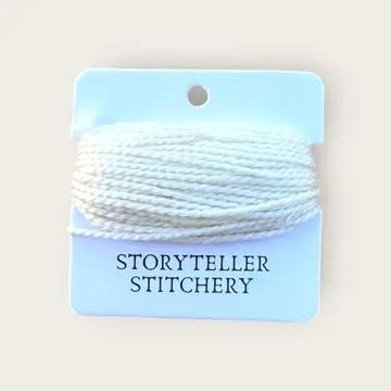 Hand-dyed embroidery thread spool, white with slight blue tint