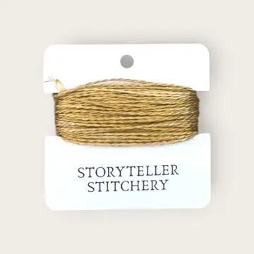 Hand-dyed embroidery thread spool, golden mustard on a card backing