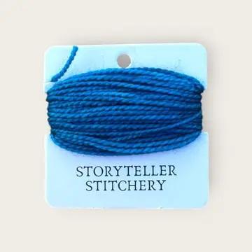 Hand-dyed embroidery thread spool, deep blue, tightly wound