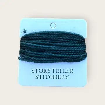 Hand-dyed embroidery thread skein, dark teal on a hanging display card