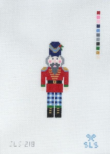Nutcracker decorative figure with blue hat, red jacket, and plaid trousers