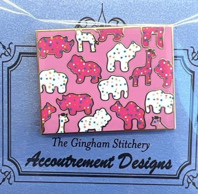 Animal Crackers needle minder on pink card with colorful dog and elephant shapes
