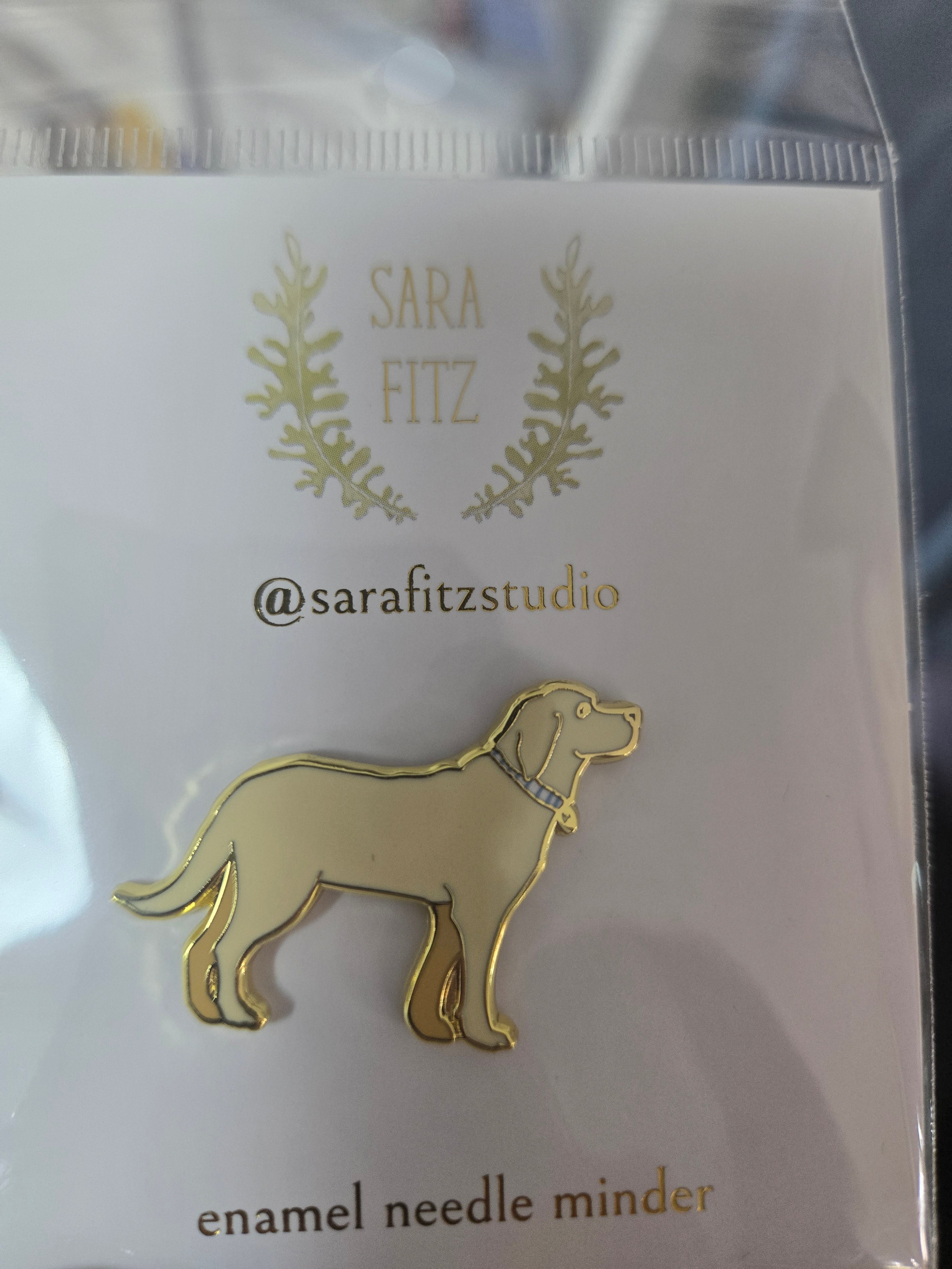 Golden Pup enamel needle minder shaped like a standing dog