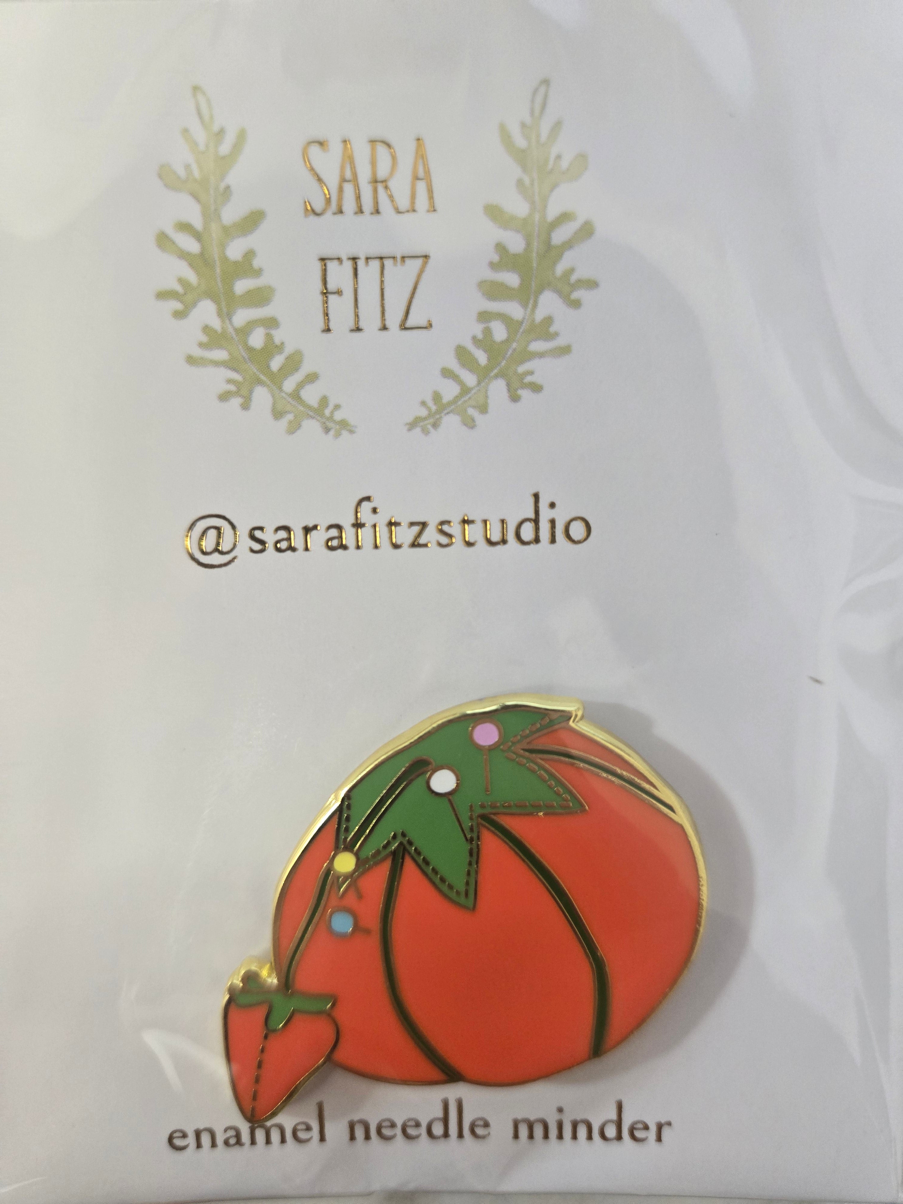 Tomato enamel needle minder with gold rim and green stem