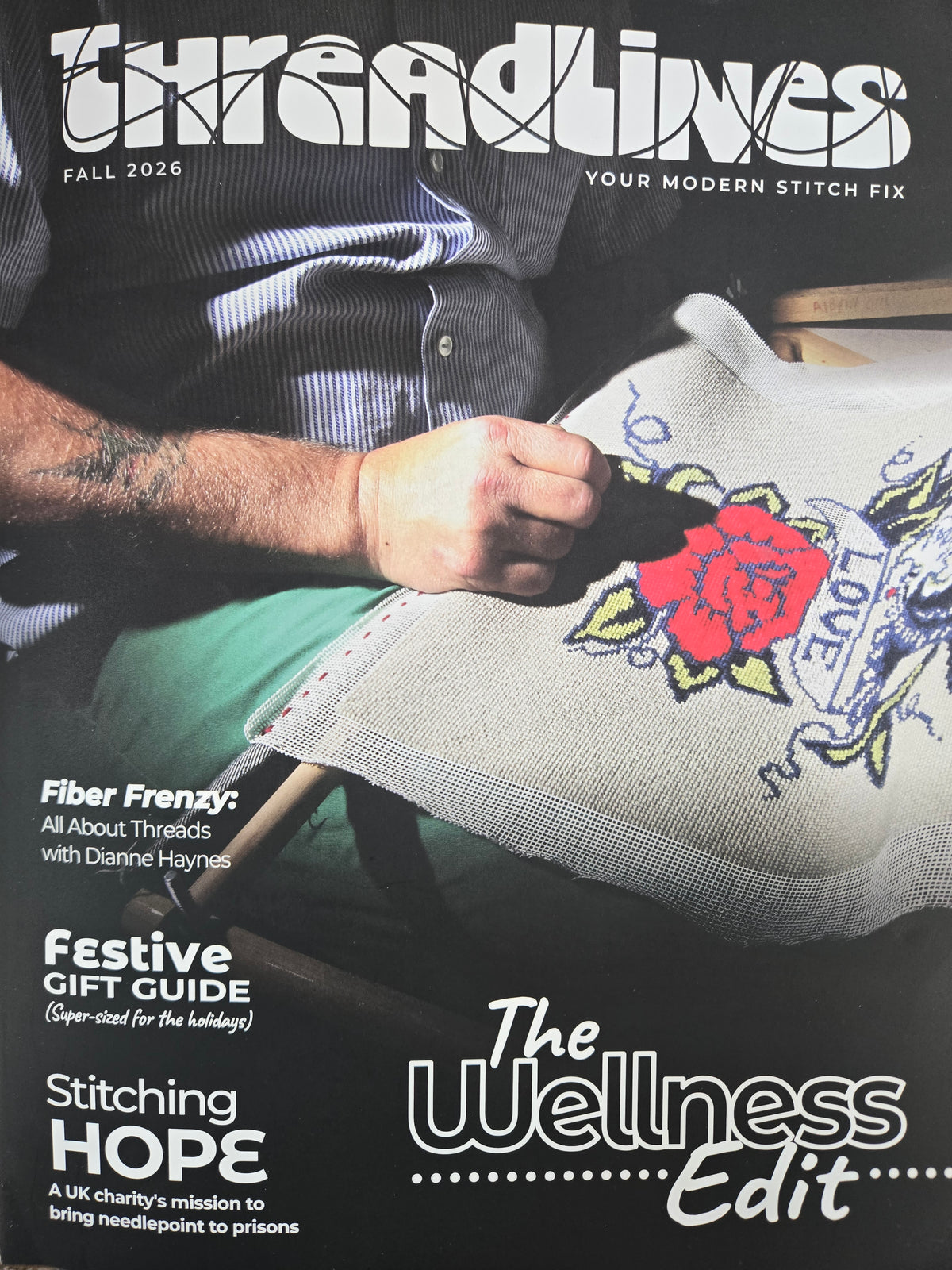 Threadlines magazine cover with stitched floral design and fabric holding scene