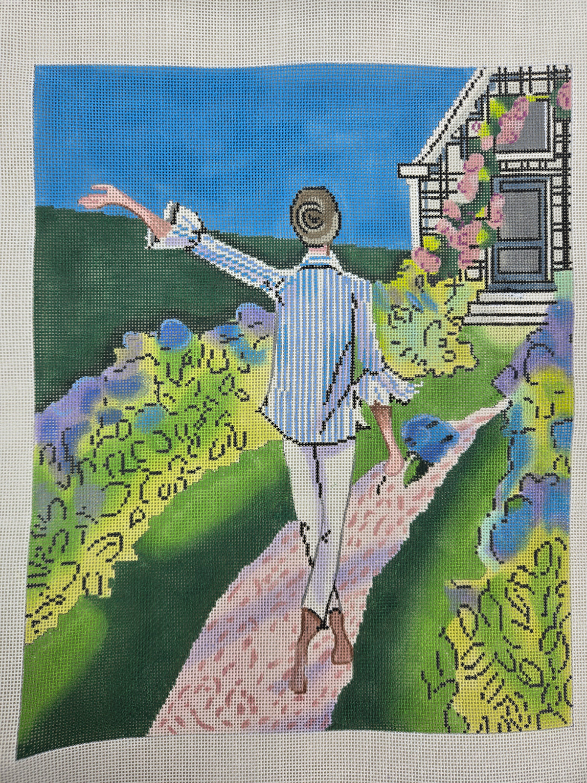 Colorful canvas print of a woman walking in a flower garden