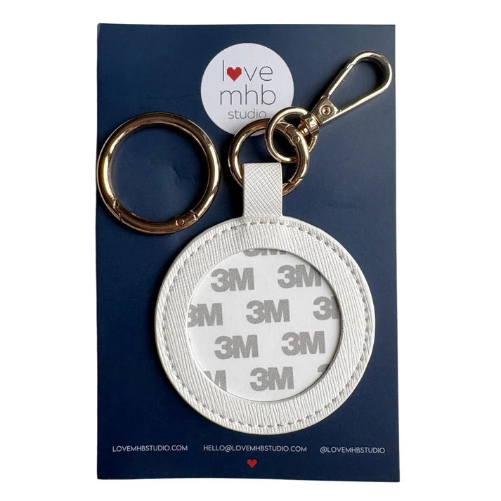 White leather needle minder charm with metal key ring and round magnet holder
