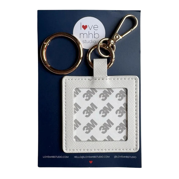 White leather needle minder charm with metal key ring and square label holder