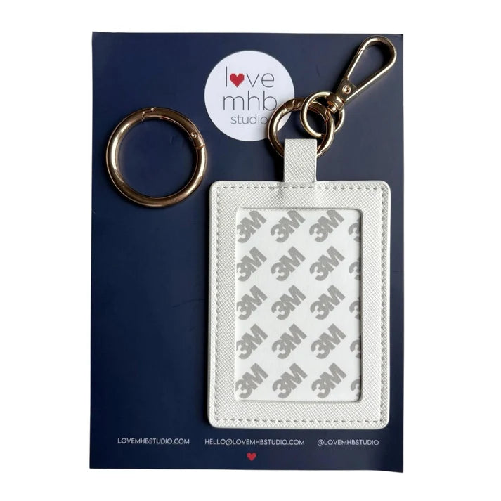 White leather needle minder charm with metal key ring and rectangular label holder